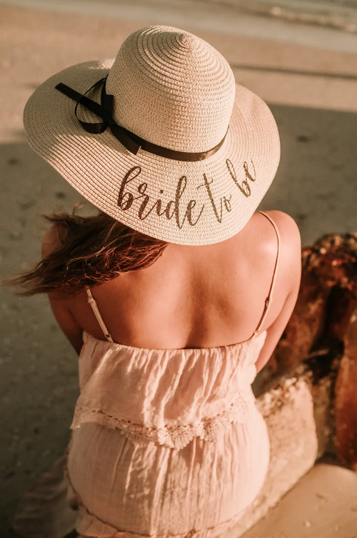 Personalised floppy sun hat with black bow embroidered 'Bride to Be' for honeymoon and beach weddings